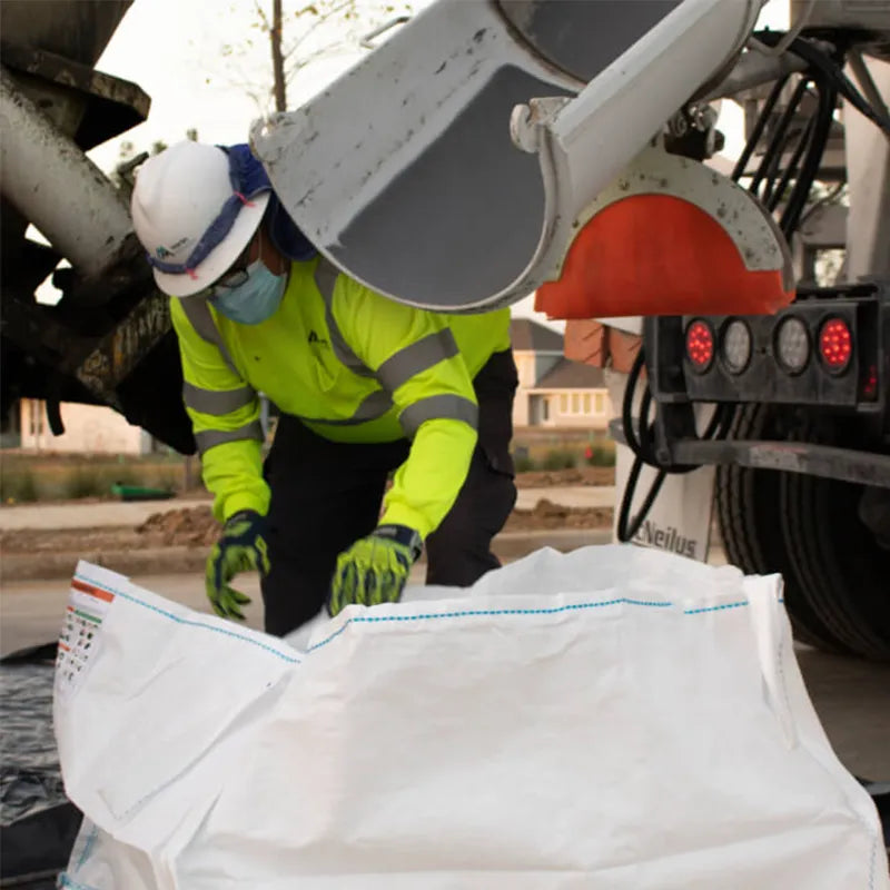 Man filling Concrete Washout to clean out concrete truck shoot